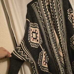Reborn ruana poncho with tribal print, size large.